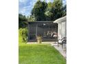 Screened-in porch with seating area and patio furniture at 2106 Switzerland Rd, North Port, FL 34288