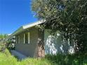Brick building with damaged windows and overgrown landscaping at 31840 Washington Loop Rd, Punta Gorda, FL 33982