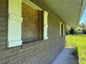 Brick wall with damaged windows and white shutters at 31840 Washington Loop Rd, Punta Gorda, FL 33982