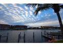 Calm waters, boat docks, and resort-style buildings at sunset at 3311 Wood Thrush Dr # 113, Punta Gorda, FL 33950