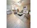 Bright living room with tiled floors and staged furniture at 6828 Ketona Rd, North Port, FL 34287