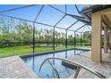 Relaxing screened-in pool area overlooking a tranquil pond at 1596 Hyssop Loop, North Port, FL 34289