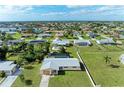A residential neighborhood featuring manicured lawns and in-ground pools surrounded by lush landscaping at 258 Shadow Nw St, Port Charlotte, FL 33952