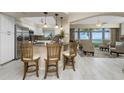Open kitchen with breakfast bar, granite counters, and water views at 1250 W Marion Ave # 242, Punta Gorda, FL 33950