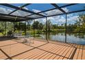 Spacious screened porch overlooking a tranquil lake, perfect for relaxing at 24395 Suncoast Blvd, Punta Gorda, FL 33980