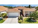One story house with tile roof and landscaped yard at 24588 Buckingham Way, Port Charlotte, FL 33980