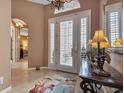 Bright entryway with tiled floors, console table, and view to the bedroom at 24588 Buckingham Way, Port Charlotte, FL 33980