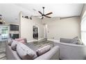 Bright living room featuring gray sofas and wood-look flooring at 3159 Draper Ter, North Port, FL 34286