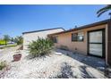 Charming single-story home featuring desert landscaping and a neutral exterior paint scheme on a sunny day at 1001 W Marion Ave # 14, Punta Gorda, FL 33950