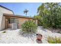 Charming single-story home featuring desert landscaping and a neutral exterior paint scheme on a sunny day at 1001 W Marion Ave # 14, Punta Gorda, FL 33950