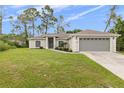 Charming one-story home, gray garage door, green lawn at 1538 Gaven Ct, North Port, FL 34288