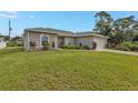 Single-story home with two-car garage and landscaped yard at 17440 Marcy Ave, Port Charlotte, FL 33948