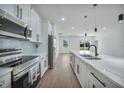 Modern kitchen with white shaker cabinets, quartz countertops, and stainless steel appliances at 16 Tee View Rd, Rotonda West, FL 33947