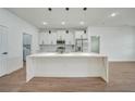 Modern kitchen with white cabinets, quartz countertops, and stainless steel appliances at 16 Tee View Rd, Rotonda West, FL 33947