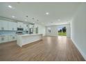 Modern kitchen with white cabinets, a large island, and stainless steel appliances at 16 Tee View Rd, Rotonda West, FL 33947