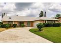Single-story house with a unique facade and landscaped yard at 2216 Pellam Blvd, Port Charlotte, FL 33948