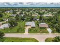 Aerial view of a canal-front house with a large yard at 2216 Pellam Blvd, Port Charlotte, FL 33948