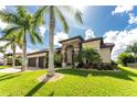 Mediterranean home with stone accents, lush landscaping, and a welcoming entryway at 259 Madrid Blvd, Punta Gorda, FL 33950