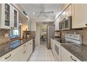 Modern kitchen featuring granite countertops and white cabinets at 286 Mark Twain Ln, Rotonda West, FL 33947