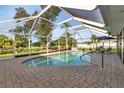 Inviting screened pool area with paver deck at 286 Mark Twain Ln, Rotonda West, FL 33947