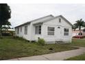 White house with front yard, steps, and small plants at 702 W Olympia Ave, Punta Gorda, FL 33950