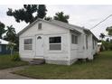 White house with front yard, steps, and small plants at 702 W Olympia Ave, Punta Gorda, FL 33950