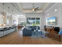 Open living room with hardwood floors and large windows at 2511 Rio Largo Ct, Punta Gorda, FL 33950