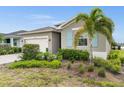 One-story house with light gray siding and blue shutters at 17708 Fallen Branch Way, Punta Gorda, FL 33982