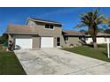 Two-story house with a driveway and a two car garage at 240 Cicero Nw St, Port Charlotte, FL 33948