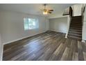 Spacious living room with laminate flooring and stairs at 240 Cicero Nw St, Port Charlotte, FL 33948