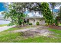 Single-story house exterior, featuring a covered entryway and landscaping at 335 Kenova St, Port Charlotte, FL 33954