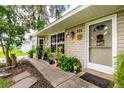 Single-story house exterior with landscaped yard and decorative accents at 335 Kenova St, Port Charlotte, FL 33954