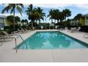 Inviting community pool with surrounding lounge chairs at 2000 Bal Harbor Blvd # 1012, Punta Gorda, FL 33950