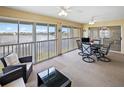 Sunroom with lake view, dining table and seating area at 26283 Nadir Rd # 201, Punta Gorda, FL 33983
