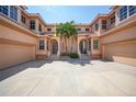 Three-story building with attached garages and lush landscaping at 3959 San Rocco Ct # 911, Punta Gorda, FL 33950
