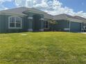 Well-maintained single-Gathering home with a vibrant green lawn at 10133 Audrey St, Port Charlotte, FL 33981