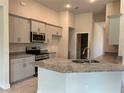 Modern kitchen with granite countertops and stainless steel appliances at 10133 Audrey St, Port Charlotte, FL 33981