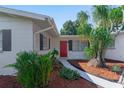 Landscaped walkway leads to the charming home's entrance at 109 Barre Nw Dr, Port Charlotte, FL 33952