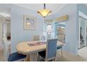 Bright dining room with table and chairs, view of kitchen at 1355 Hempstead Ave, North Port, FL 34286