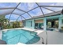 Inviting screened pool area with spacious patio and access to the interior at 1355 Hempstead Ave, North Port, FL 34286