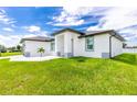 Single story home with white exterior, gray accents, and landscaping at 2743 Hopwood Rd, North Port, FL 34287