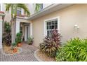 Private entryway with lush tropical landscaping and brick pavers at 2630 Tarpon Cove Dr # 212, Punta Gorda, FL 33950