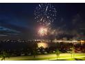 Scenic view of fireworks over the water, reflecting light onto the nearby buildings and parked cars at 1425 Park Beach Cir # 127, Punta Gorda, FL 33950
