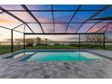 Relaxing pool and patio area with screened enclosure and water views at 6100 Riverside Dr, Punta Gorda, FL 33982