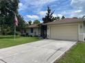 House exterior with driveway and American flag at 4088 Felhorn St, Port Charlotte, FL 33948