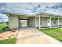 Covered carport and side view of house at 1638 Harmony Dr, Port Charlotte, FL 33952