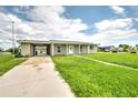 Updated one-story home with a carport and front yard at 1638 Harmony Dr, Port Charlotte, FL 33952