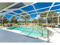 Inviting kidney-shaped pool with screened enclosure, offering a relaxing outdoor oasis at 16407 San Edmundo Rd, Punta Gorda, FL 33955