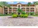 Building exterior showcasing architectural details, landscaping, and a brick paved driveway at 89 Vivante Blvd # 305, Punta Gorda, FL 33950
