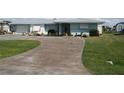 Long concrete driveway leading to a light blue house at 305 W Tarpon Nw Blvd, Port Charlotte, FL 33952